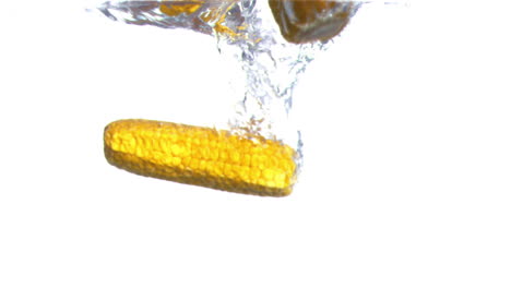 corn cobs falling into water in super slow motion