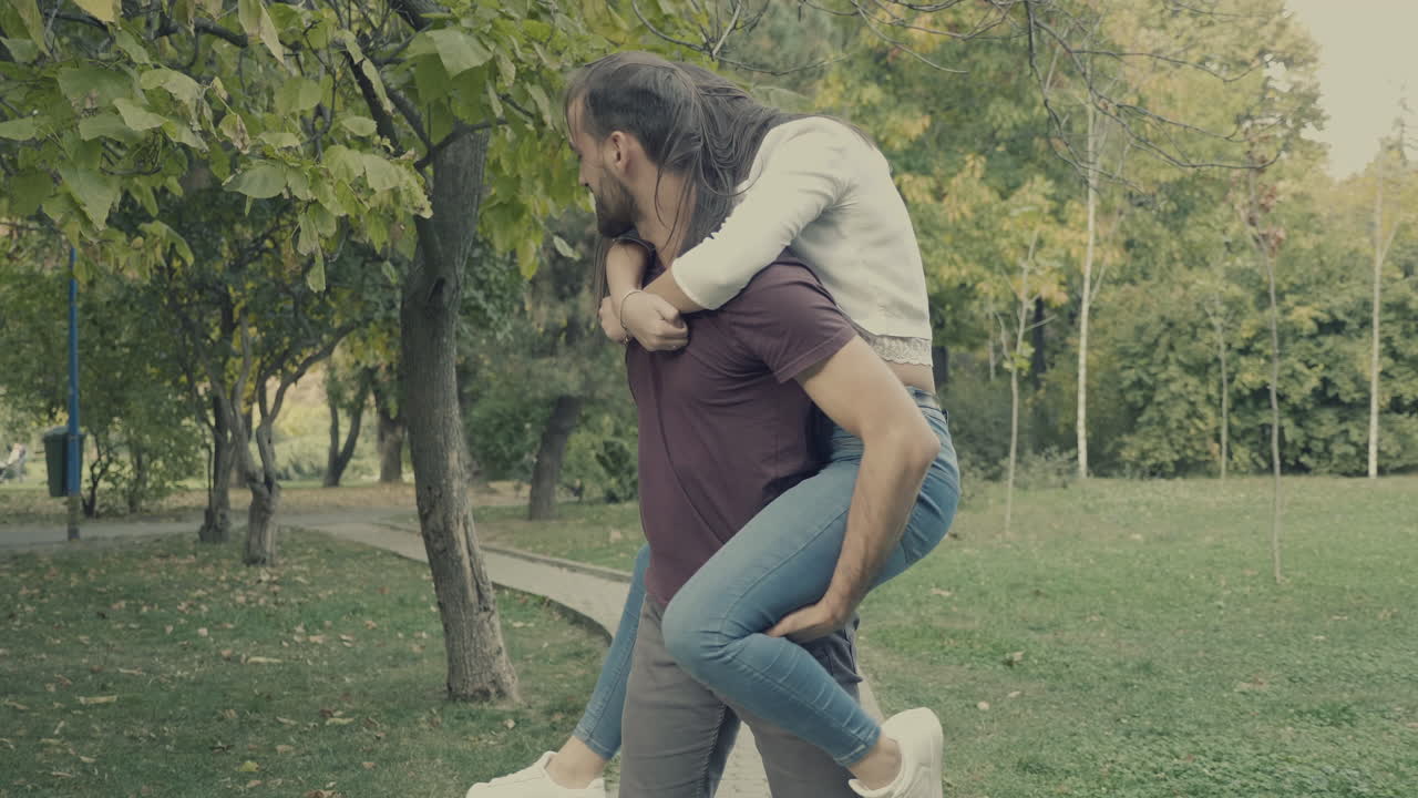 Couple enjoying a piggyback ride in the park