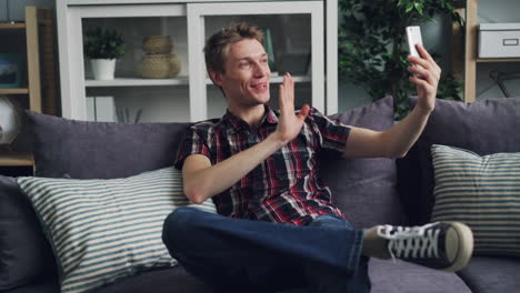 man taking a selfie on the couch