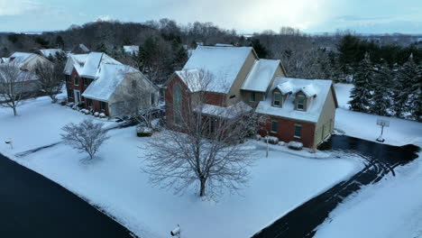 Single-family-red-brick-two-story-home-in-winter-snow