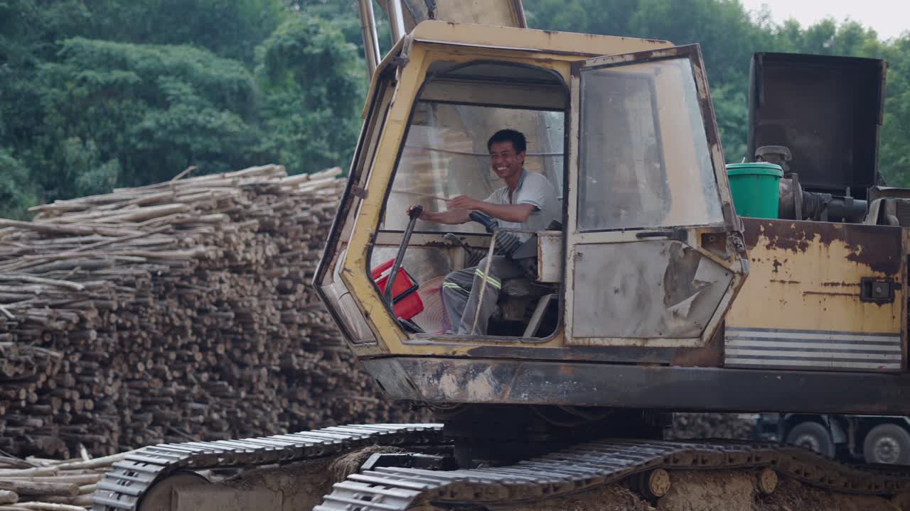 Worker operating a logging excavator