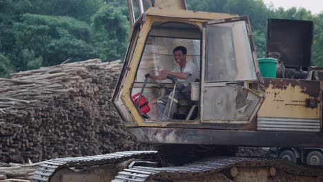 worker operating a logging excavator