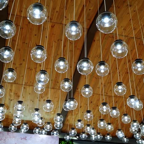 creative interior of many lamps. modern ceiling lighting of hanging light bulbs indoors.