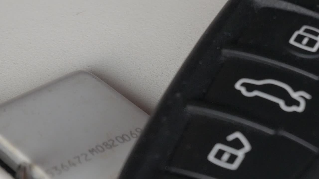Close-up of car keys on a table, focusing on key details
