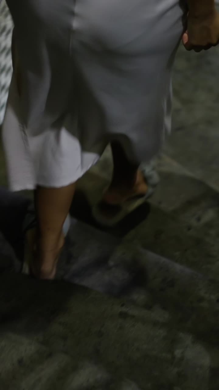 A woman in a white dress walking
