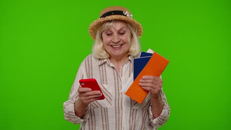 mature woman traveler tourist browsing on mobile phone and looking for holiday resort vacation trip