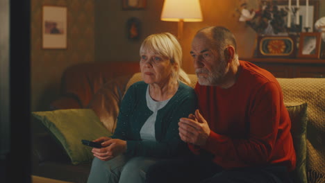 elderly couple watching television