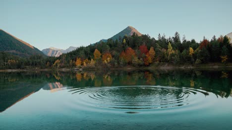 mountain lake in the austrian alps with vibrant autumn leaves and reflection, close to germany