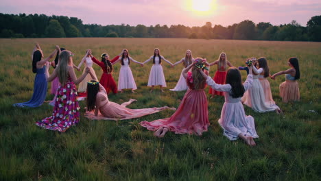 women in a circle dance at sunset