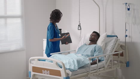 a female doctor is talking to a patient in a hospital ward. recovery after treatment is the beginning of rehabilitation.