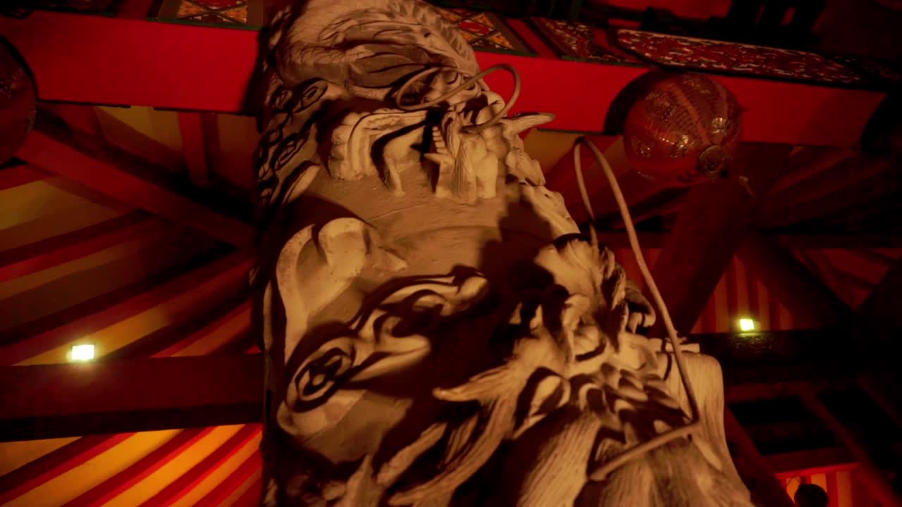 Historic pagoda building interior. Ornament with beautiful dragon shape on pillar with dim lights at night. Sam Poo Kong temple, Semarang, Indonesia