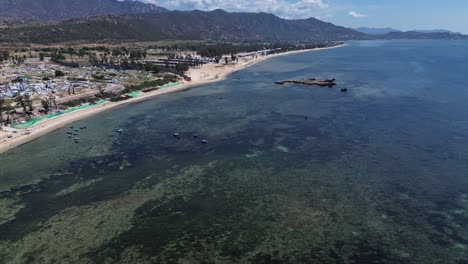 aerial semi orbit showcasing traditional fishing boats anchored in the bay of ninh hải district under clear blue skies.