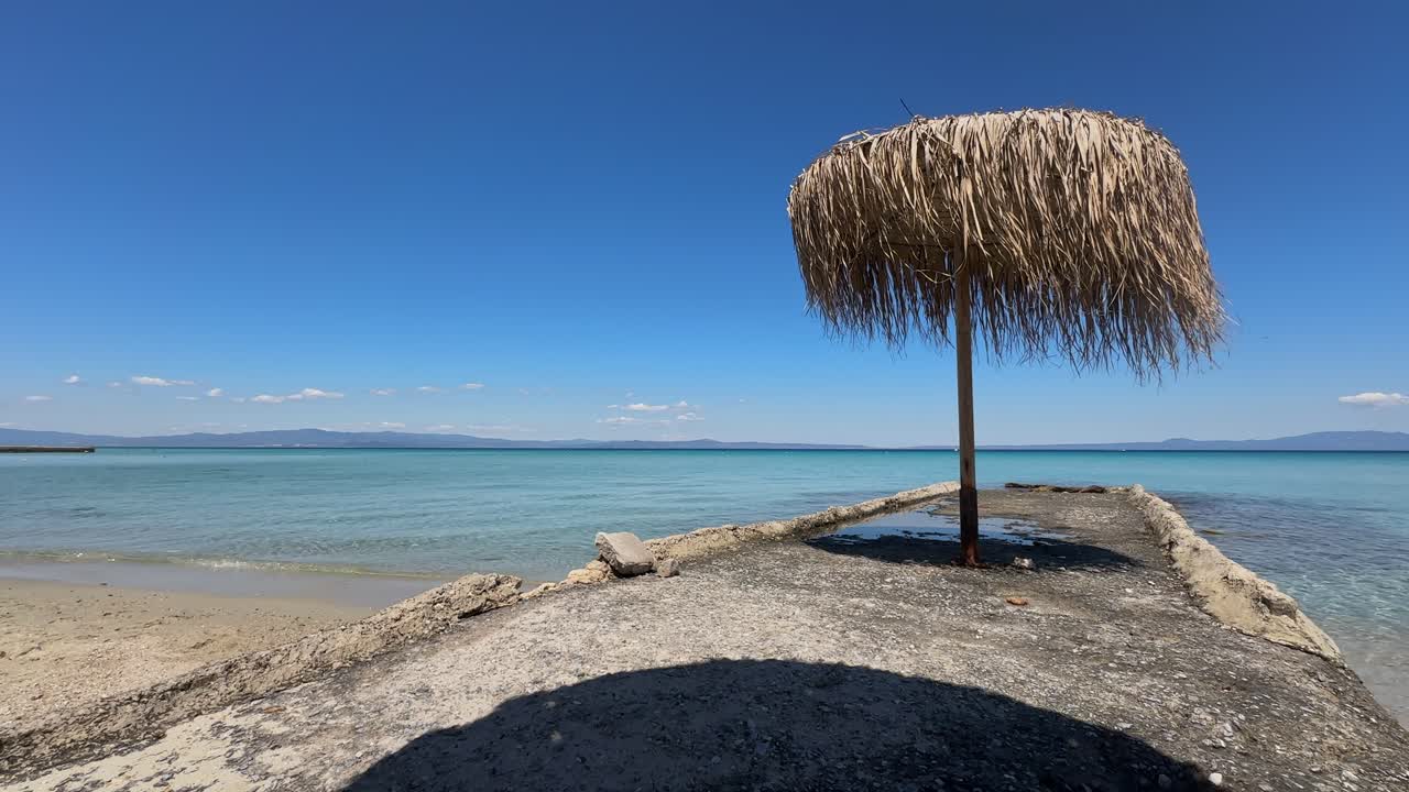 Stunning beach scene in Halkidiki, Greece, with elegant sunbeds facing the crystal-clear turquoise sea. A perfect summer escape in the heart of the Aegean.
