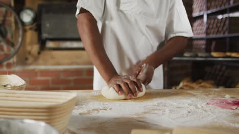 Animation-of-midsection-of-african-american-male-baker-preparing-sourdough-for-bread