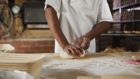 animation of midsection of african american male baker preparing sourdough for bread