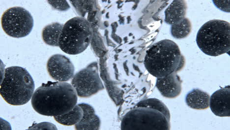 Bubbled-aqua-making-funnel-with-berries-closeup.-Fruit-cocktail-spinning-vessel