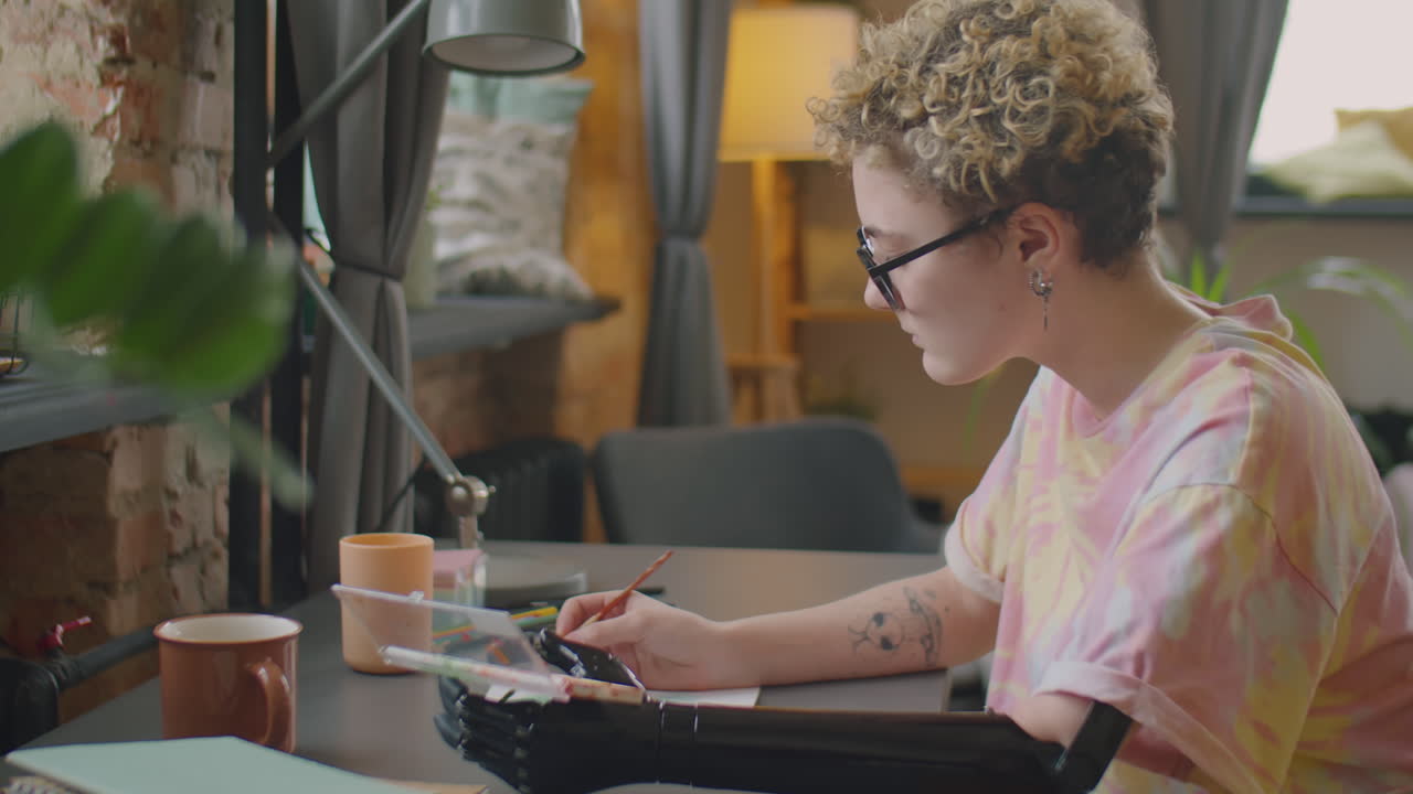Girl with Prosthetic Arm Painting at Home