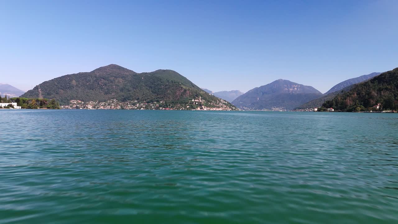 Fly over Lake Lugano towards Morcote Switzerland