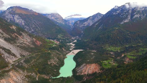 fly above italy’s vajont dam, framed by towering cliffs and tranquil water.