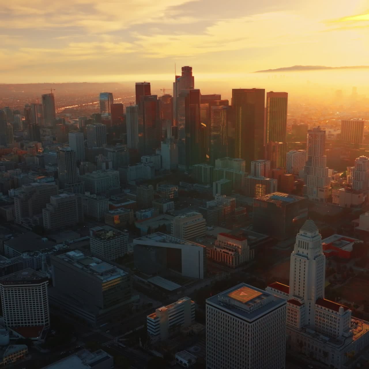 Immense scenery of stunning Los Angeles at sunset. Downtown with skyscrapers from aerial perspective