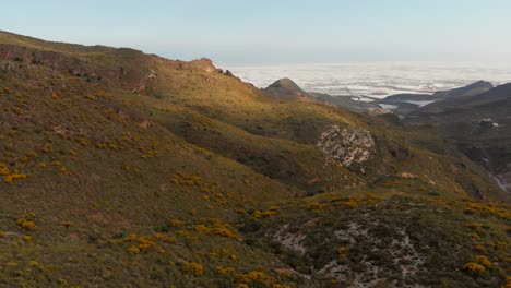 The-mountains-near-Almeria-in-the-south-of-Spain-with-in-the-background-the-greenhouses,-Aerial-shot