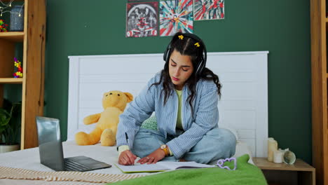 young woman studying in her bedroom