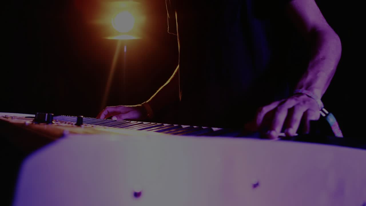 Male keyboardist performing music, causing camera rising and globe overlay shifting across torso