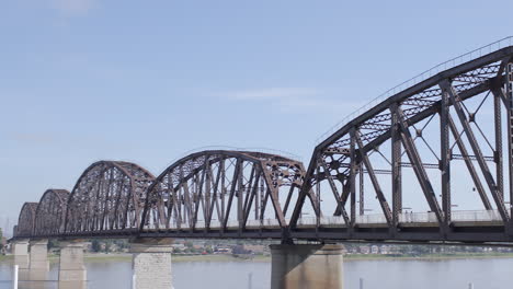 closeup view of the big four bridge over the ohio river towards jeffersonville indiana with a pan left on a sunny summer day