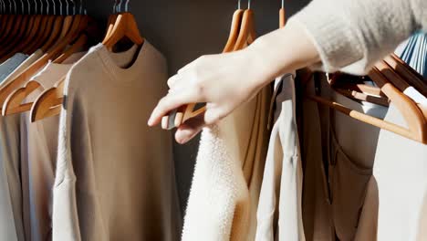 organized beige clothes in a closet