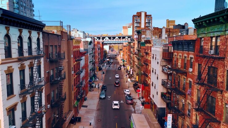 Street of New York with residential houses. Drone footage along the buildings with balconies and ladders.