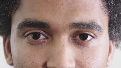 close up young mixed race man opening eyes looking at camera eyesight vision