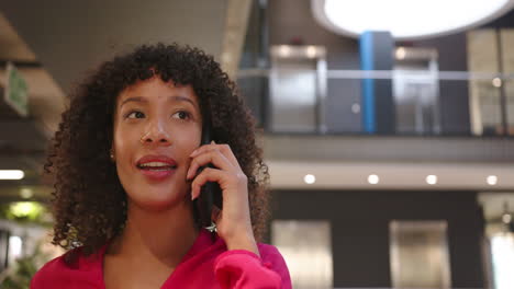 talking on smartphone, businesswoman in office building, focusing on conversation, copy space