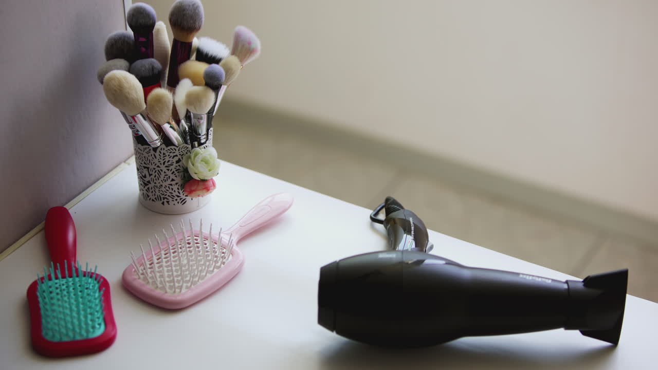 Woman styling hair and makeup