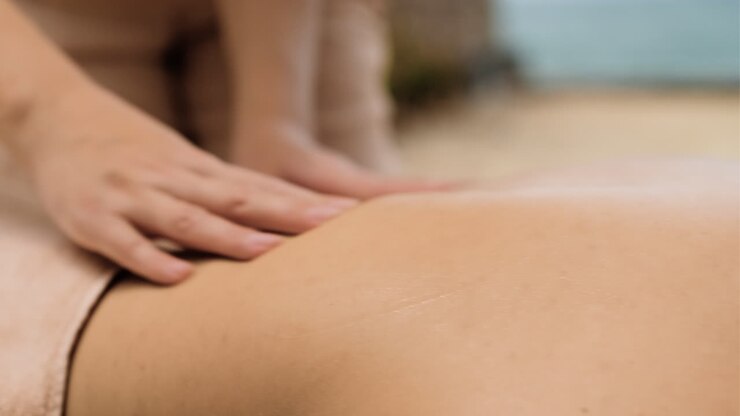 Masseuse giving massage to woman