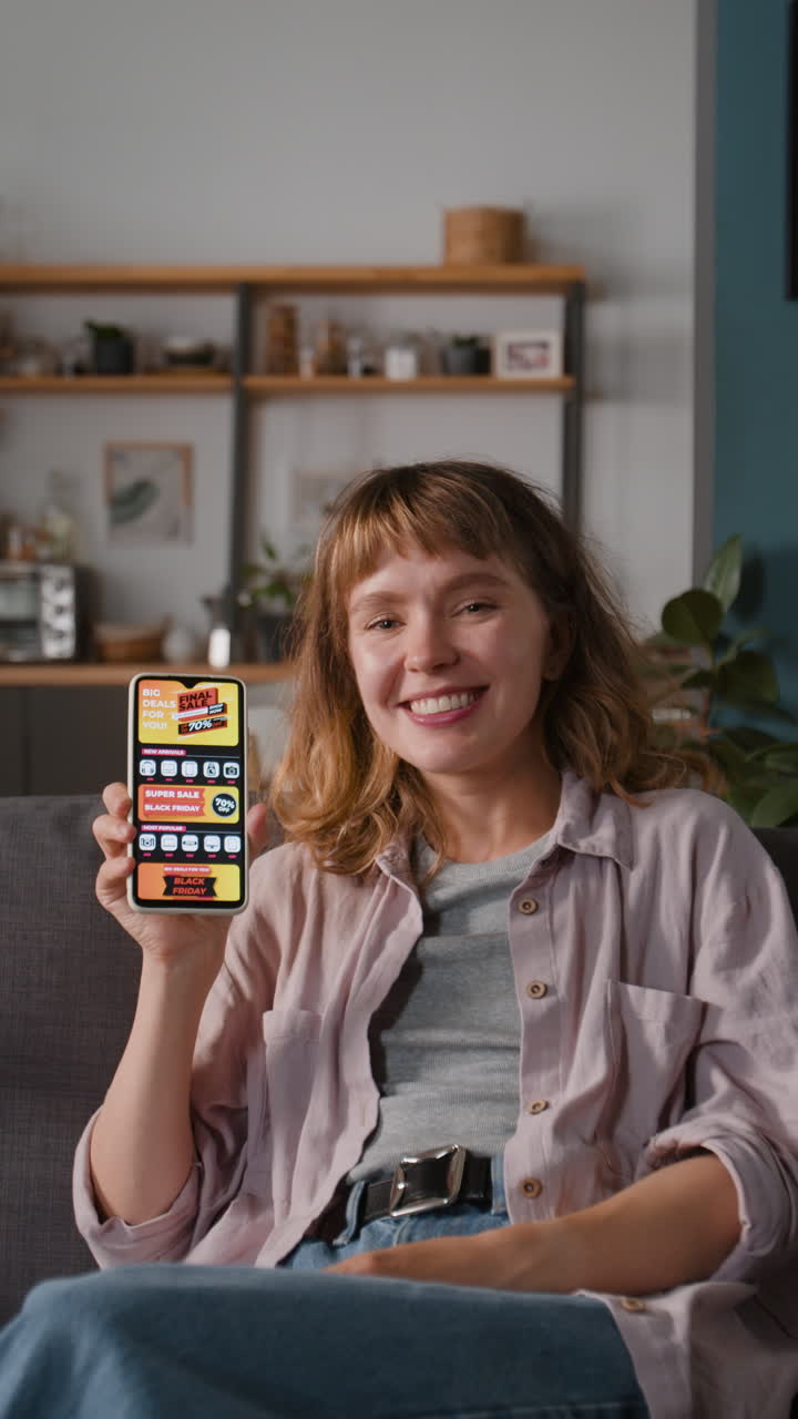 A woman using a mobile phone in her living room