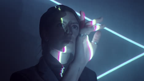 woman standing in dark room with laser lines projection