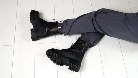 woman wearing black chunky boots and grey sweatpants