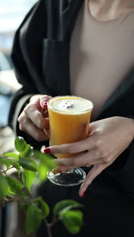 woman holding a warm drink