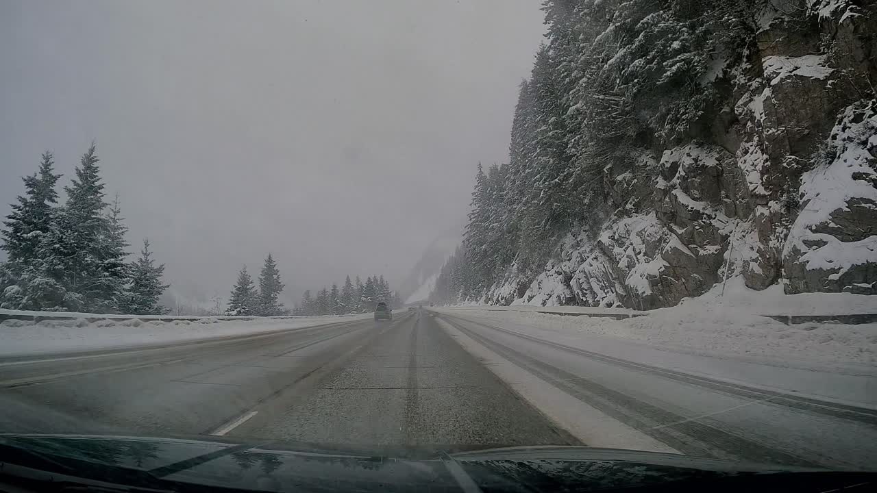 Driving through Snow Covered Snoqualmie Mountain Pass at Washington