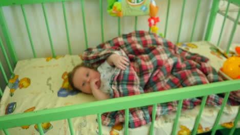 adorable baby boy lying in crib