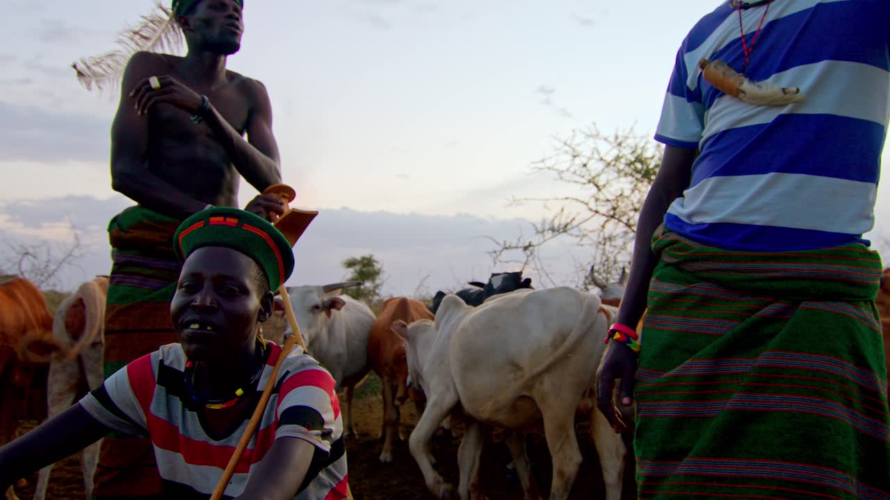 Karamojong Cattle Farmers Surrounded by Their Cows in Uganda, Africa - Close Up
