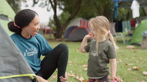 child, camp counsellor and high five with support