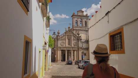woman walks toward historic church