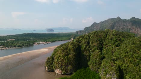 drone revealing a large sandbar, mangroves and mountains in ao thalane krabi thailand on a sunny day