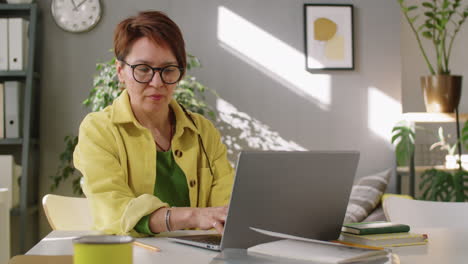 Middle-Age-Businesswoman-Working-on-Laptop-in-Office