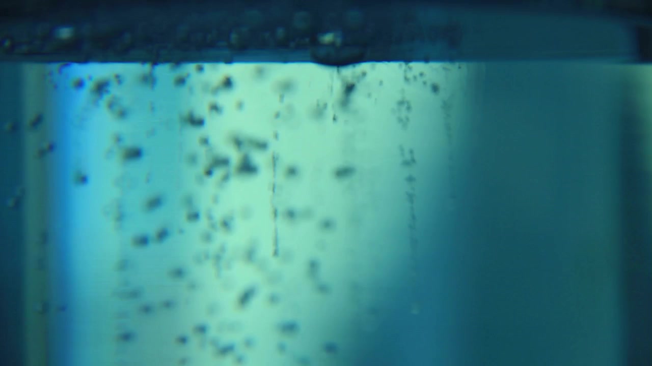Pouring salt pieces in to blue water creates bubbles