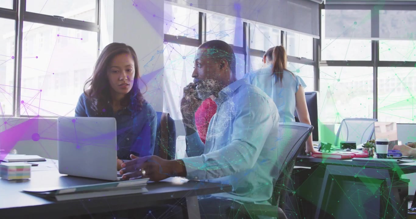 Coworkers leaning into laptop after pointing at screen collaborating on business report and typing