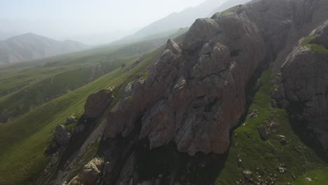 Drone-shot-of-a-large-rock-outcroping-in-the-Kakshaal-Too-mountain-range-in-Kyrgyzstan