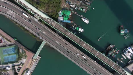 aerial view of a bridge with traffic and boats