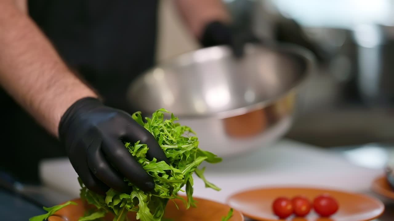 Work in the restaurant kitchen. Chefs in protective gloves preparing food in the kitchen